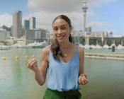 Still from the TVNZ show "Passengers" depicting Sonia Grey introducing the show with the Sky Tower as background.