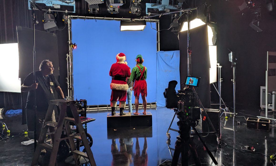 Auckland cameraman Christo Montes lighting a blue screen set for TVNZ